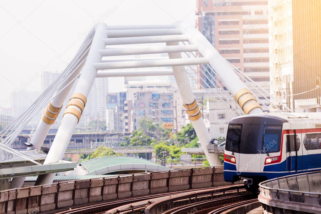 Electric skytrain is running in downtown of Bangkok metropolitan region. It is running on railroad tracks.
