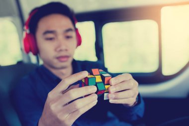Bangkok, Tayland - 31 Ekim 2018: İlgilenmemi Ruchimethakun programcı var. Rubik küpü - teknik ve iş çözme sorunu ve beyin eğitimi kavramı elinde. Van seyahat faaliyetleri.