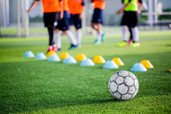 Futbol topu ile yeşil yapay çim makinesi koniler ve eğitim oyuncu bulanık. Futbol Akademisi