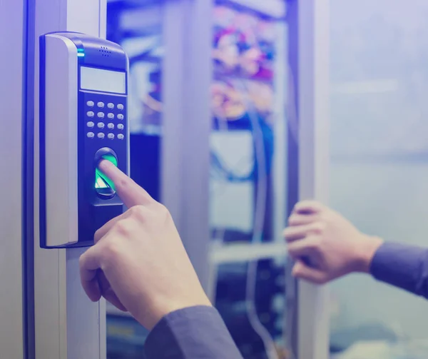 Staff push down electronic control machine with finger scan to access the door of control room or data center. The concept of data security or data access control.