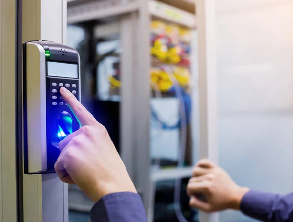 Staff push down electronic control machine with finger scan to access the door of control room or data center. The concept of data security or data access control.