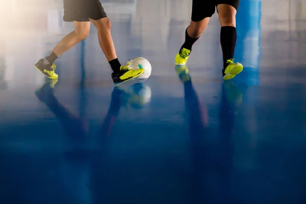 Indoor soccer sports hall. Football futsal player, ball, futsal floor. Sports background. Youth futsal league. Indoor football players with classic soccer ball.