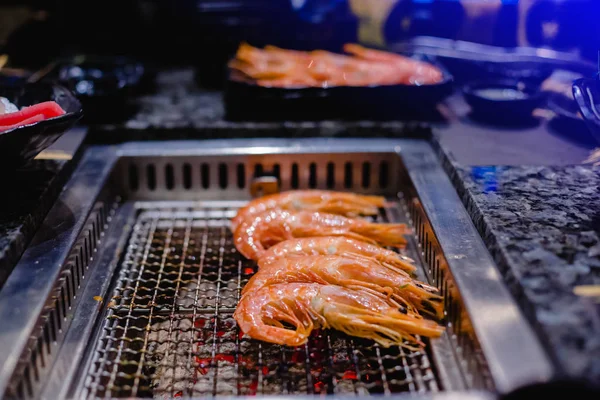 grilling shrimp on stove for grilling in restaurant. Stove for grilling in restaurant.