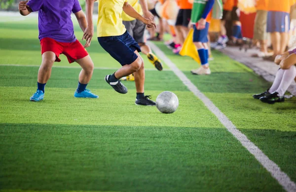 soccer players run to trap and control the ball for shoot to goal with cheerleader team background. Soccer players fighting each other by kicking the ball