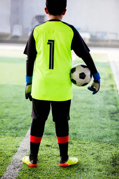soccer ball in hands of goalkeeper.  Soccer player training or football match.