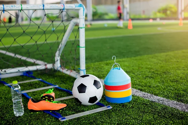 Brocas escada, gol, bola de futebol, cones marcador, sapatos esportivos e — Fotografia de Stock