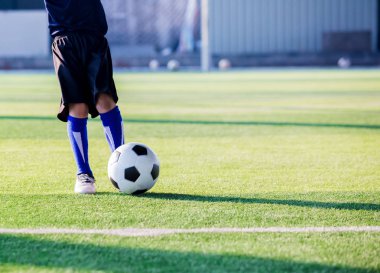 Çocuk futbol oyuncu hız çalıştırmak topu hedefe yeşil çimenlerin üzerinde ateş