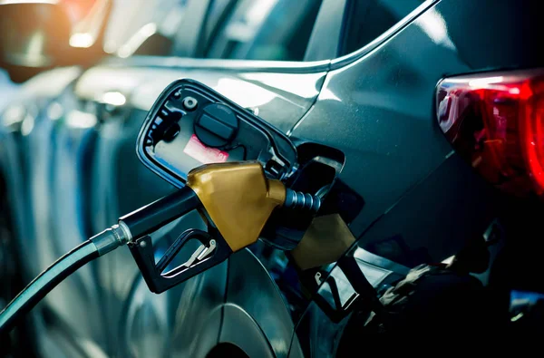 Hand refilling the car with fuel at the refuel station — Stock Photo, Image