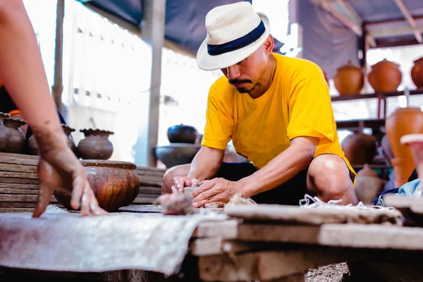 pottery, workshop, ceramics art concept - closeup on male hands