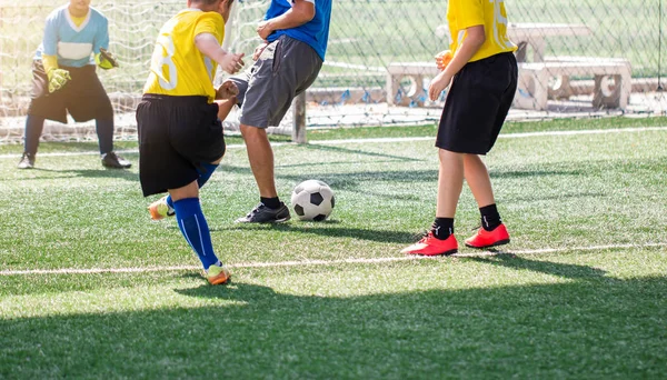 Selective to kid soccer player and coach are training and fighti — Stock Photo, Image