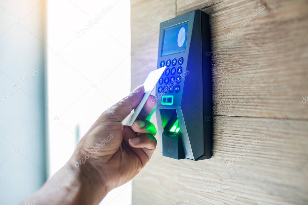 Door access control. Staff holding a key card to lock and unlock