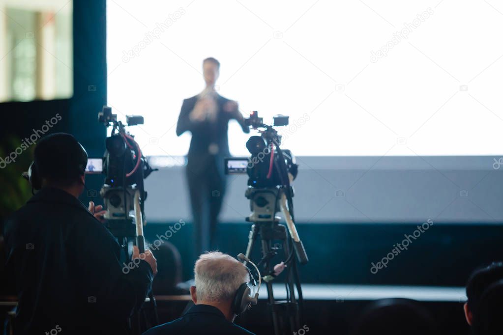 Video camera set record speaker and audience in conference hall 