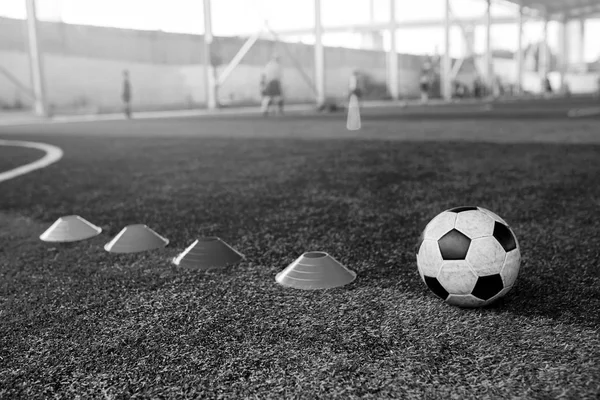 Black and white iamge of cone marker and football are soccer tra — Stock Photo, Image