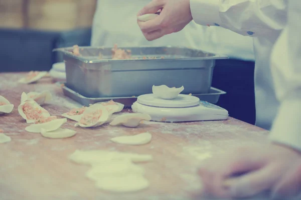 在著名的餐厅里, 点心厨师们在包装饺子的工作 — 图库照片
