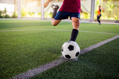 Futbol oyuncu hız çalıştırmak topu hedefe suni çim üzerinde ateş