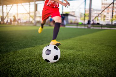 Futbol oyuncu hız çalıştırmak topu hedefe suni çim üzerinde ateş