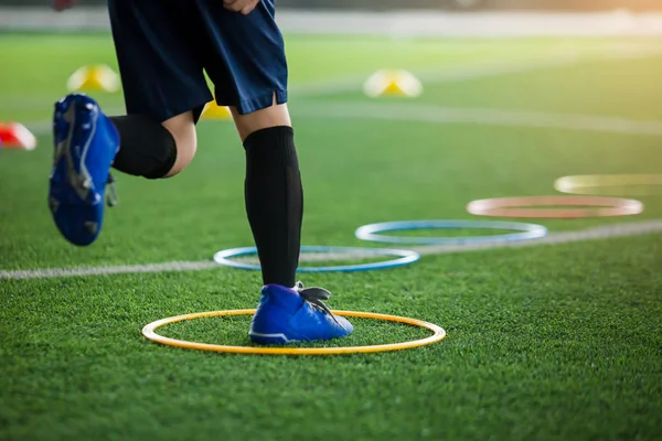 selective focus to kid soccer player Jogging and jump at ring la