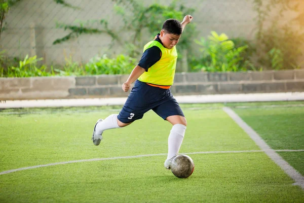 Velocità giocatore di calcio eseguito su tappeto erboso artificiale verde per sparare palla t — Foto Stock