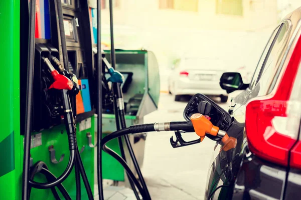 A fekete autó újratöltését üzemanyaggal a benzinkútnál, utántöltő — Stock Fotó