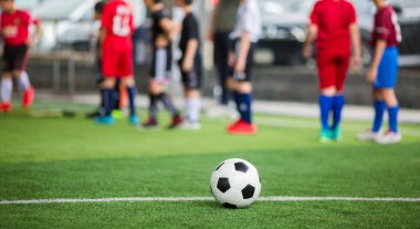 Yeşil suni sahada futbol topu ve bulanık futbol takımı tra