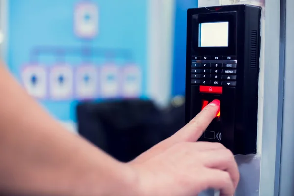 Staff push down electronic control machine with finger scan to access the door of control room or data center. The concept of data security or data access control.