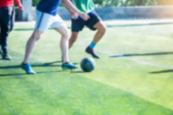 Blurry picture of sport background. Soccer player control and shoot ball to goal with goalkeeper. Soccer players fighting with goalkeeper.