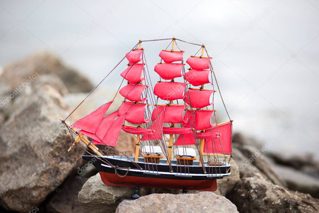 Scarlet Sails. A lone ship against the morning sky. Ship in the water. Alexander Green. Photography for Alexander Green's novel. Ship with scarlet sails in the river 