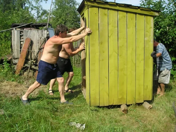 Drei Männer Ziehen Ein Häuschen Dorf — Stockfoto