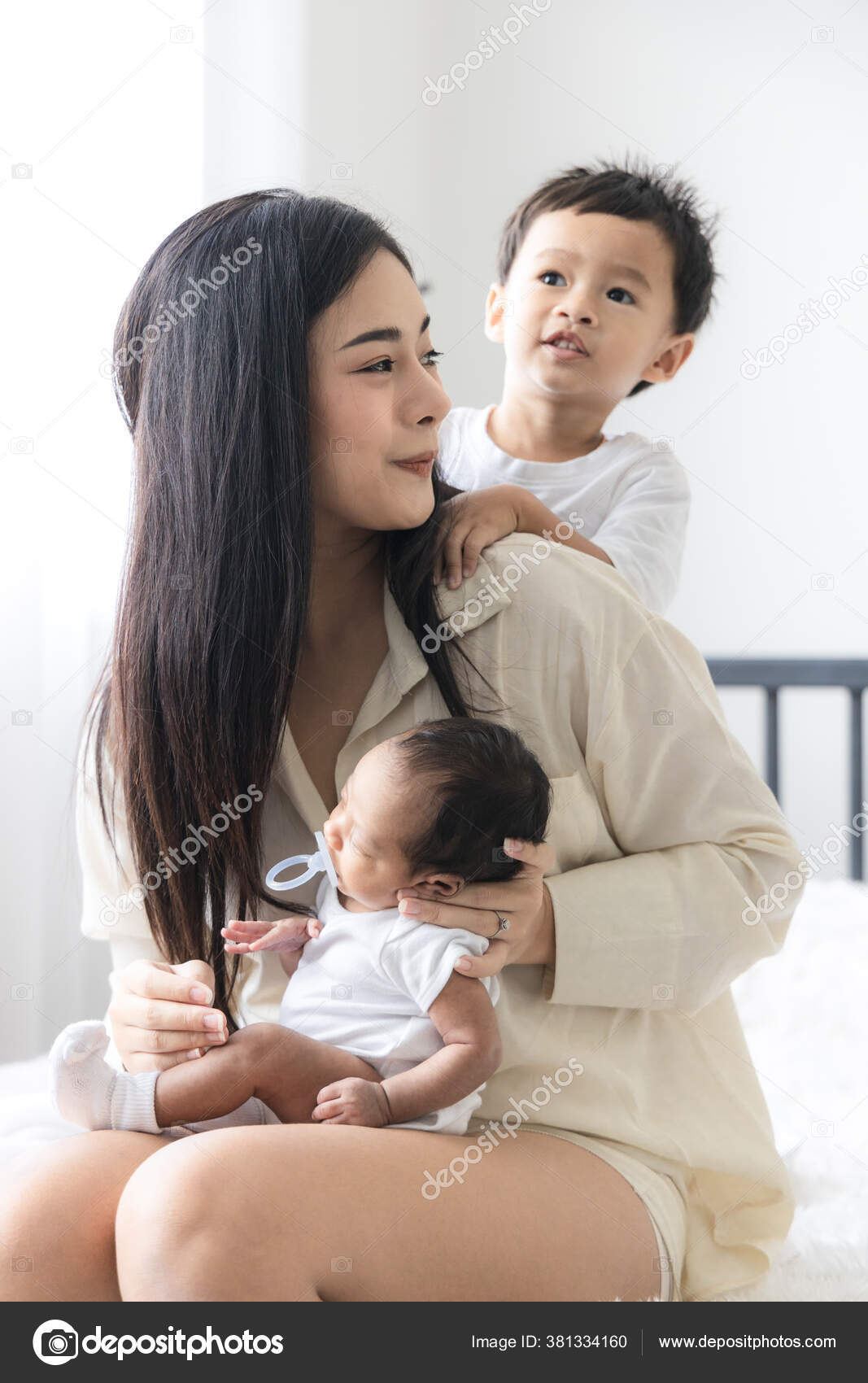 Young Asian Mother Hugging Cute Newborn Baby Sucking Fake Nipples Stock  Photo by ©amornchaijj 381334160