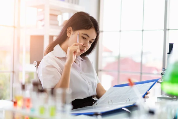 Asian girl students are doing science experiments in a science lab.