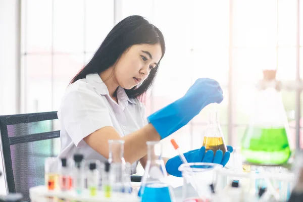 Asian girl students are doing science experiments in a science lab.