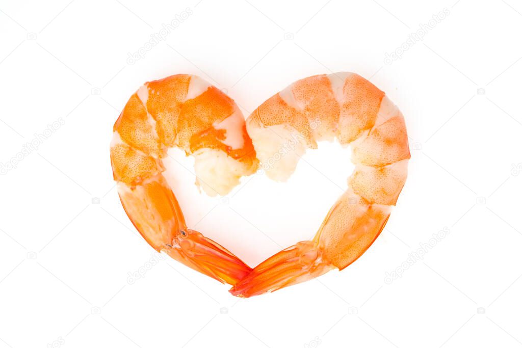 Boiled shrimps are heart shaped on white background.