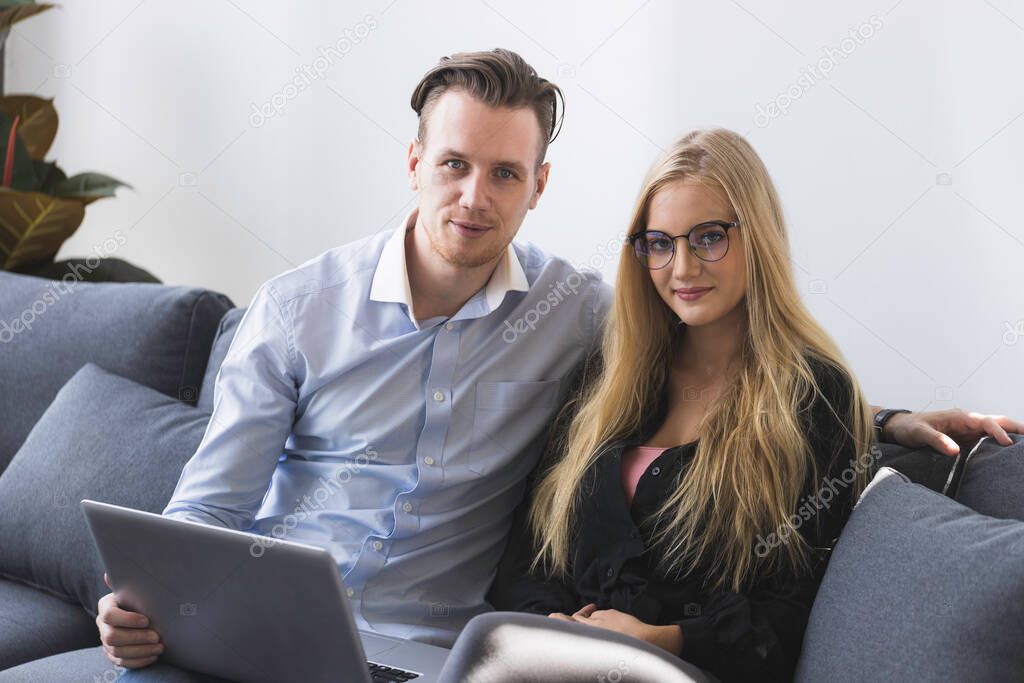 Young business man and woman working from home-office with morning sunshine. they are communicating in social network and searching information online.