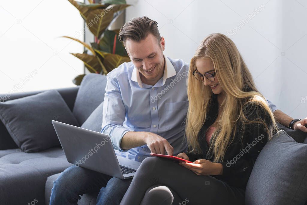 Young business man and woman working from home-office with morning sunshine. they are communicating in social network and searching information online.