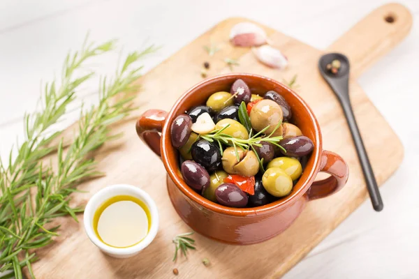 Marinated olives with garlic, rosemary, olive oil and spices. Rustic style Tasty appetizer