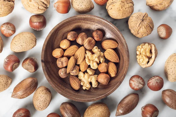 Nuts Mixed in a wooden plate — Stock Photo, Image