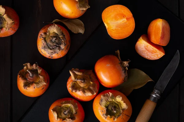 Persimmon still life in low key — Stock Photo, Image