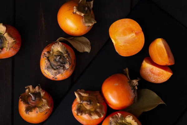 Persimmon still life in low key — Stock Photo, Image