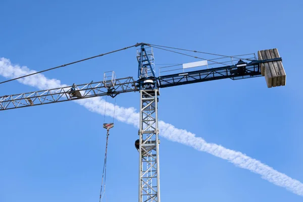 Stavební jeřáb proti modré obloze — Stock fotografie