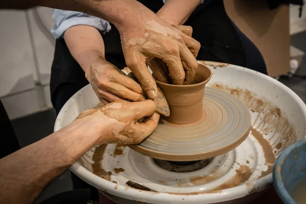 Potter especialista ensinar uma mulher a trabalhar na roda de oleiro — Fotografia de Stock
