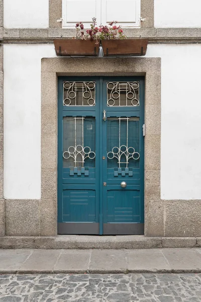 Antique door on building facade made of wood wrought iron and glass. Modernist architecture — Stock Photo, Image