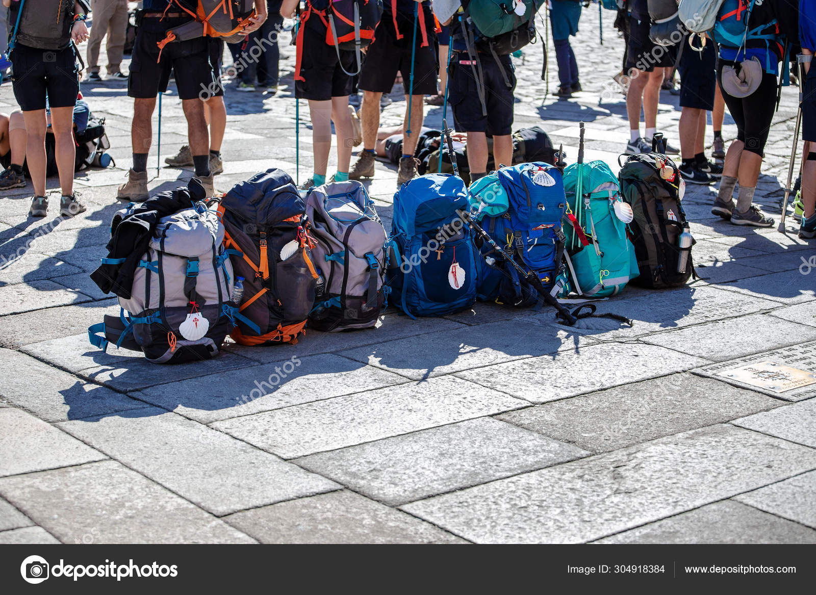 Group Of Pilgrim Backpack In A Row On Paving Stone Of Obradoiro Square Santiago De Compostela Spain Stock Editorial Photo C Andresvic
