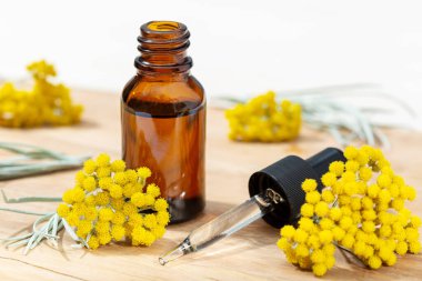 Helchrysum esaslı yağı kehribar şişesi ve pipette. Bitkisel ilaç yağı.