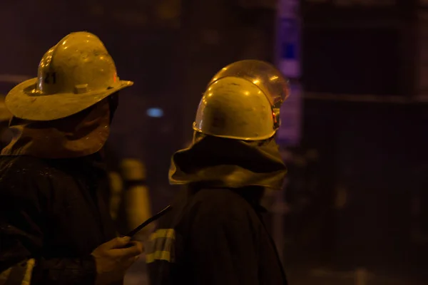 Brandweerlieden op het werk. bluswater in de winter nacht. Fire Tower, brand slang. Kiev, 20 januari 2018 — Stockfoto