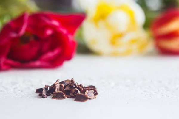 A heap of dried black flower seeds close-up on a white table background. planting season. close up top view copy space — Stock Photo, Image