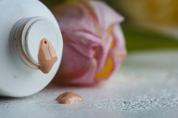 plastic mouth tube with cream and open lid close-up on a white table. cosmetics for body care close-up on a blurred background