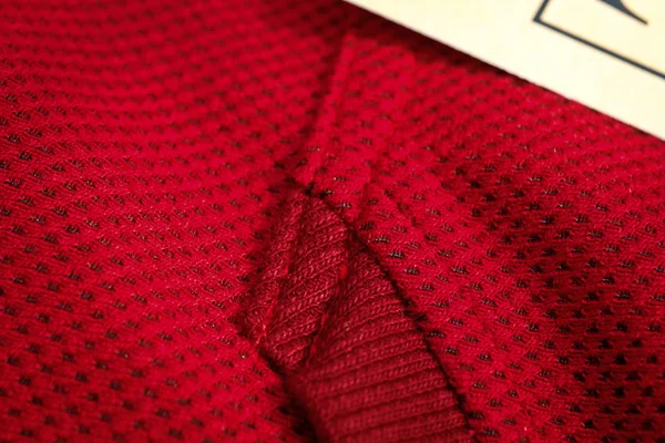 Red sportswear closeup top view. seam and juncture. breathable knitwear. clothing details macro — Stock Photo, Image