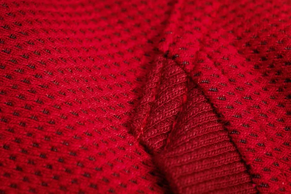 Red sportswear closeup top view. seam and juncture. breathable knitwear. clothing details macro — Stock Photo, Image