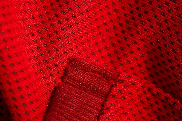 Red sportswear closeup top view. seam and juncture. breathable knitwear. clothing details macro — Stock Photo, Image