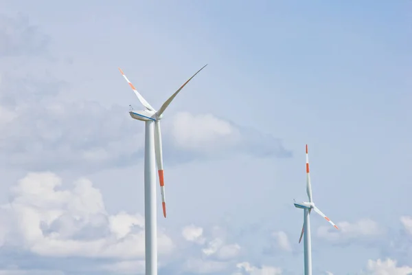 wind power plant on the background of bright cloudy sky. wind generator close-up. green electricity, alternative energy